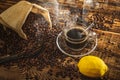 Coffee cup and beans on old kitchen table. Top view with copy space for your text. coffee bag and with Ã¢â¬â¹Ã¢â¬â¹lemons on wooden